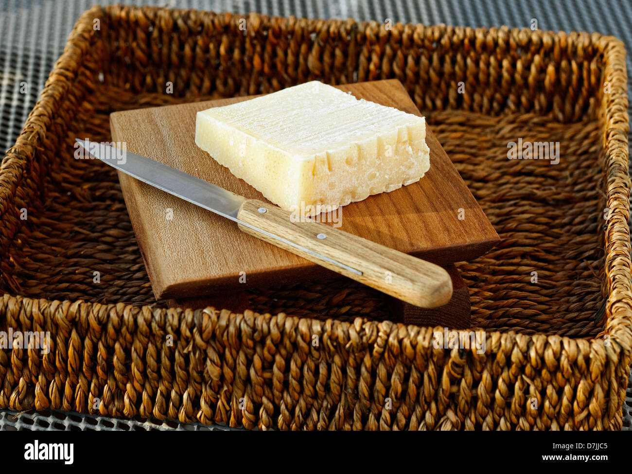 Cheese in basket with cheese knife Stock Photo Alamy