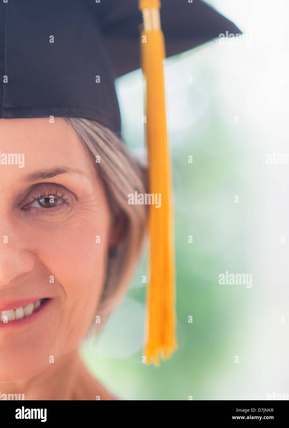 Portrait of woman in graduation cap Stock Photo