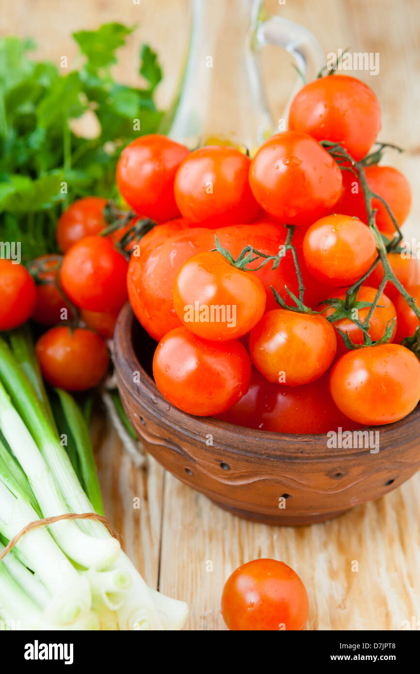 ripe red cherry tomatoes in a bowl, food Stock Photo - Alamy
