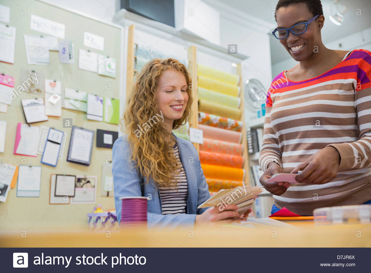 Female small business owner assisting customer with options Stock Photo