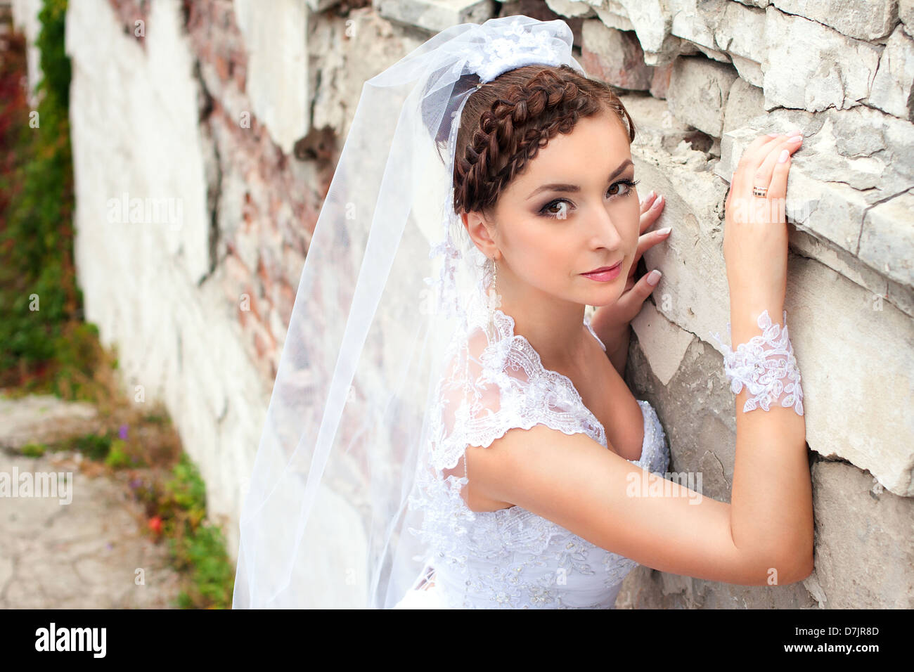 Romantic portrait of the beautiful bride near pillars Stock Photo