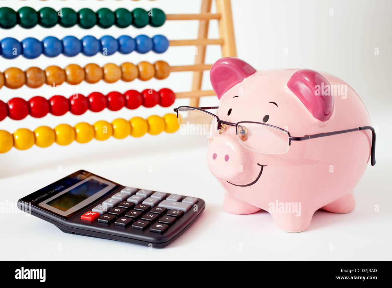 Smiling pink piggy bank wearing glasses with a calculator and abacus ...