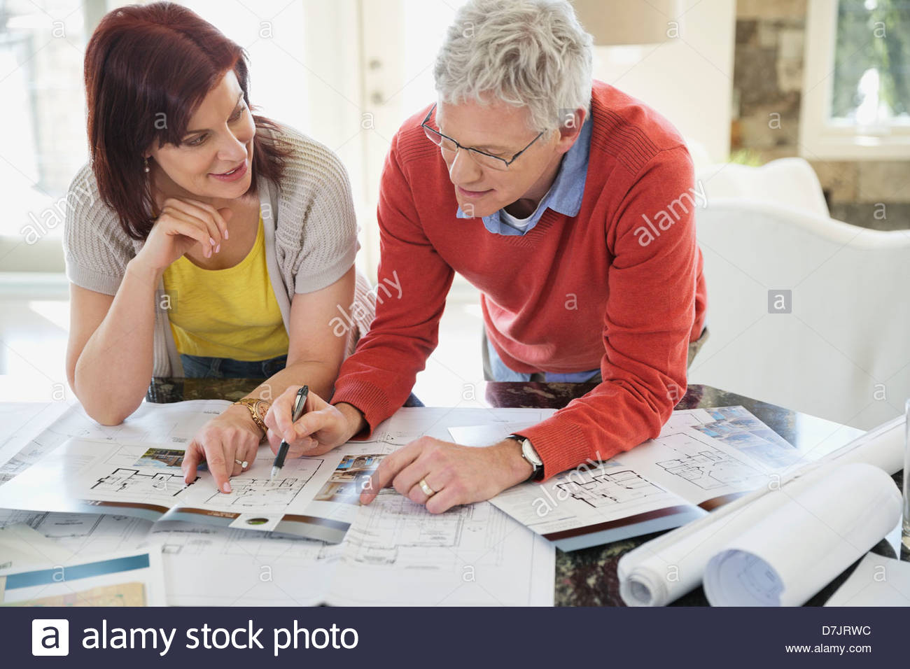 Mature couple discussing home designs in kitchen Stock Photo