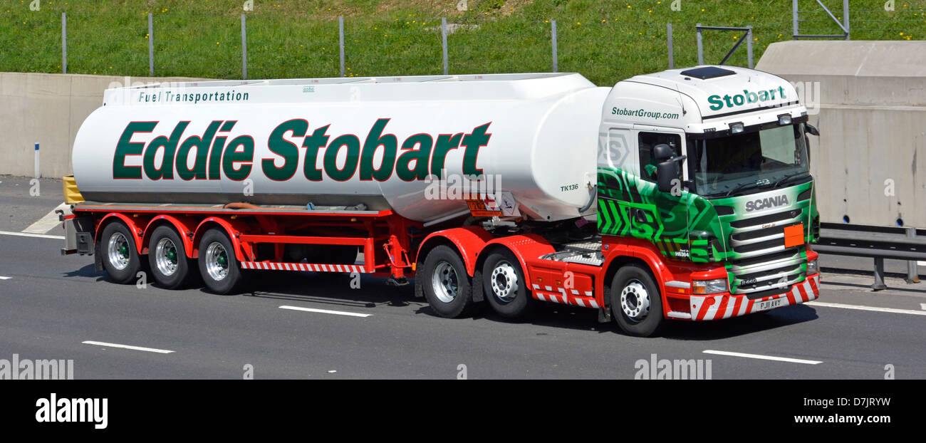 Fuel tanker articulated trailer & hgv prim mover Scania lorry truck  operated by haulier Eddie Stobart driving on M25 London orbital motorway road UK Stock Photo
