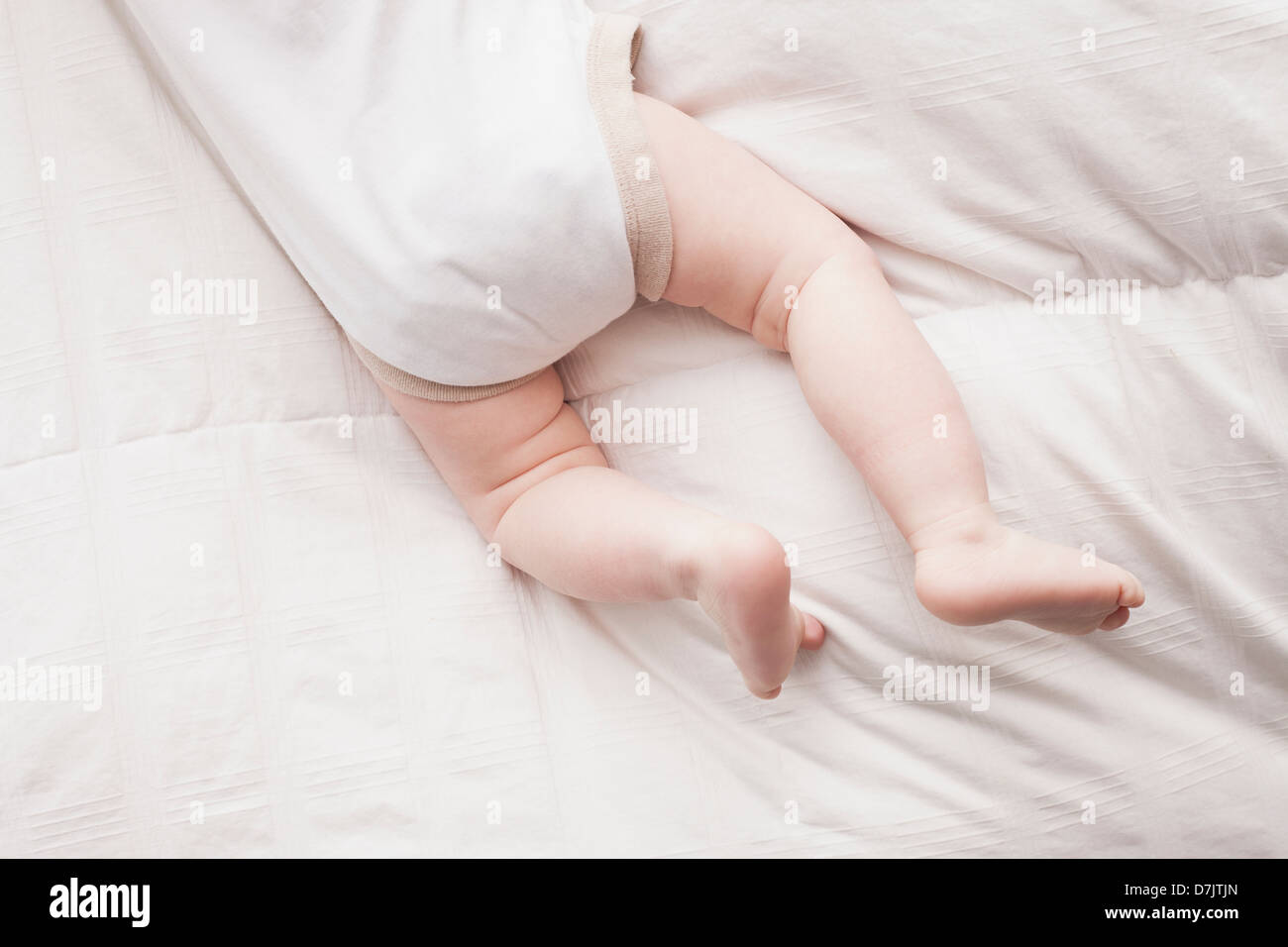 Low section of baby boy (18-23 months) lying on front Stock Photo