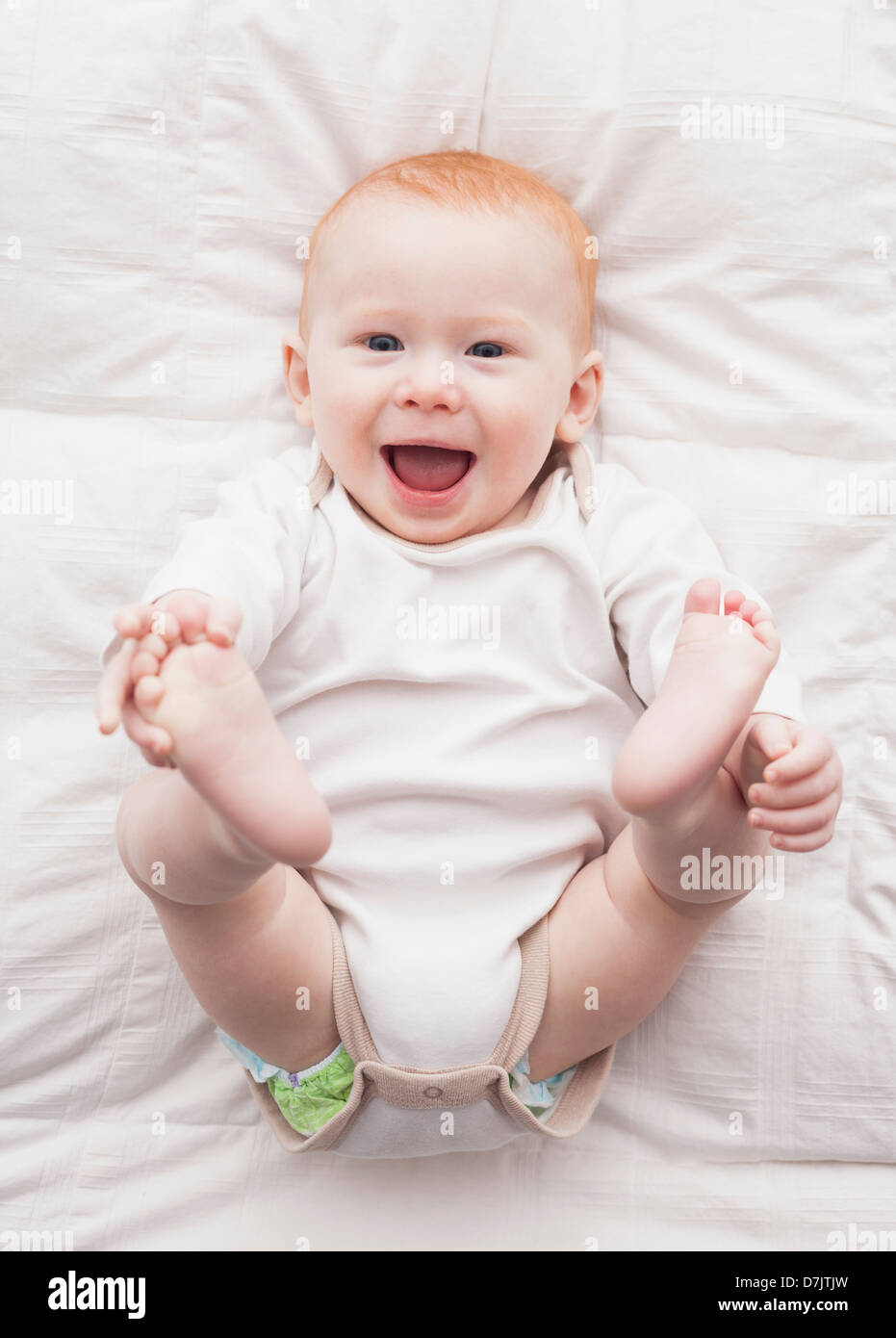 Directly above portrait of baby boy (18-23 months) lying down Stock Photo