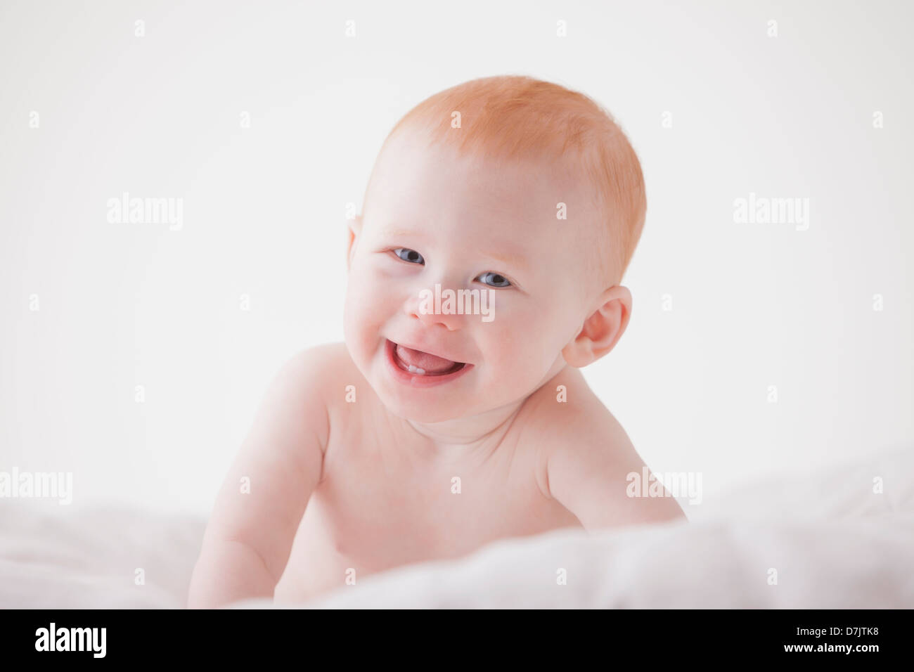 Portrait of baby boy (18-23 months) laughing Stock Photo