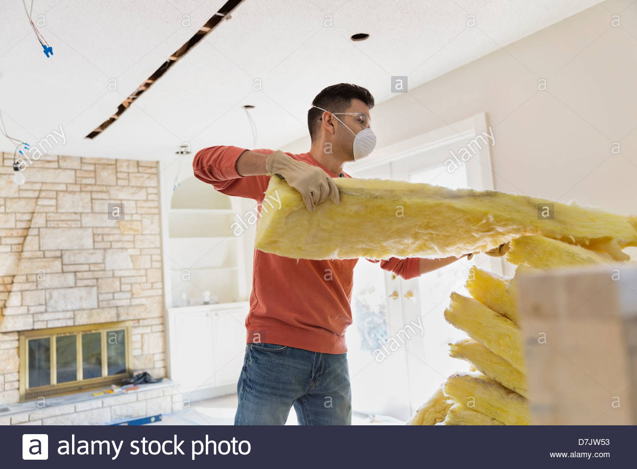 Young man installing insulation at home Stock Photo