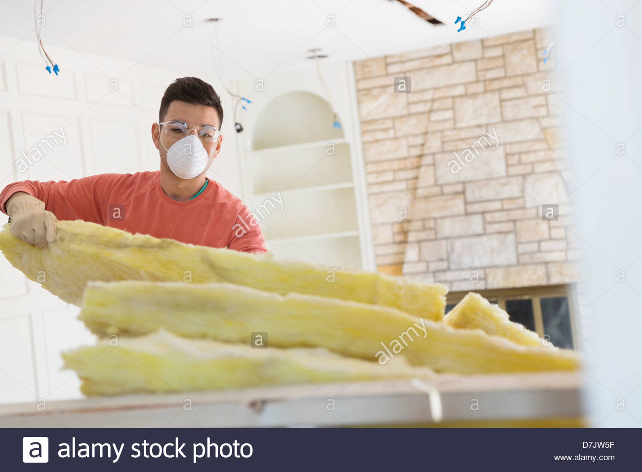 Young man installing insulation at home Stock Photo