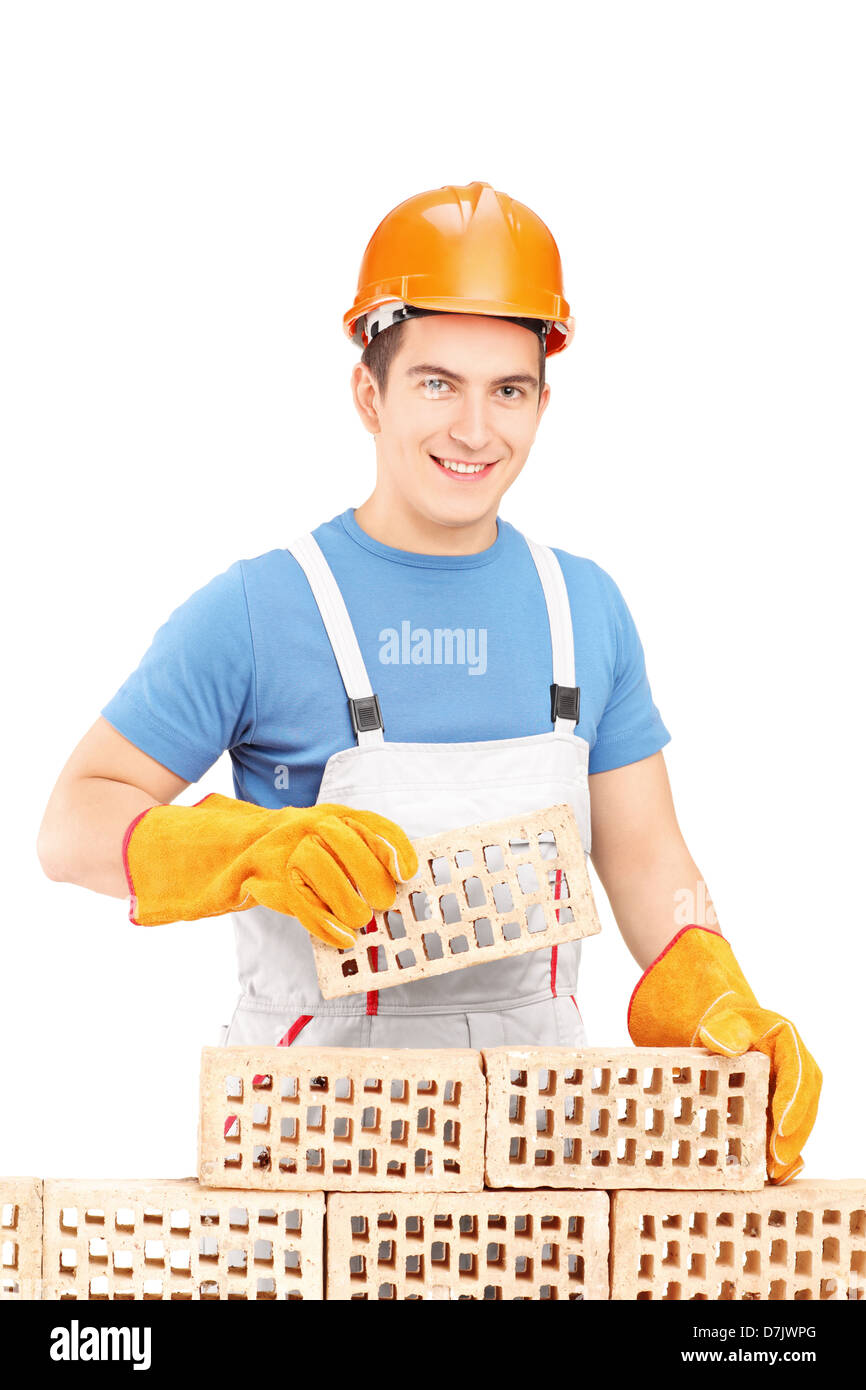 Male manual worker building a brick wall isolated on white background Stock Photo