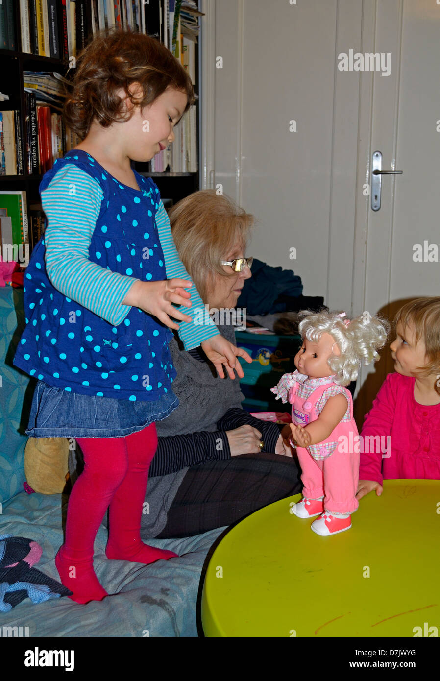 4 year old little girl playing with her doll Stock Photo - Alamy