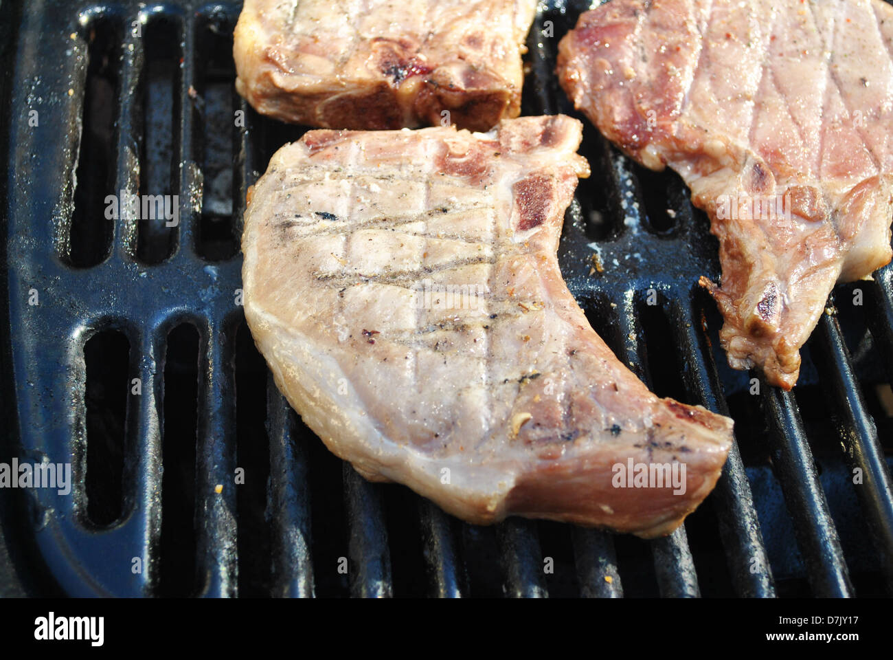 Grilling Pork Chops on a Summer Grill Stock Photo