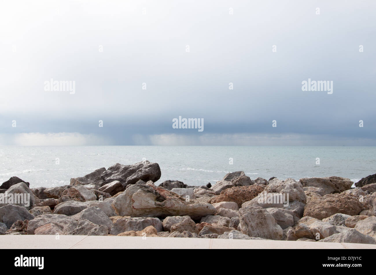 Rocks, ocean, rains - wider. Stock Photo