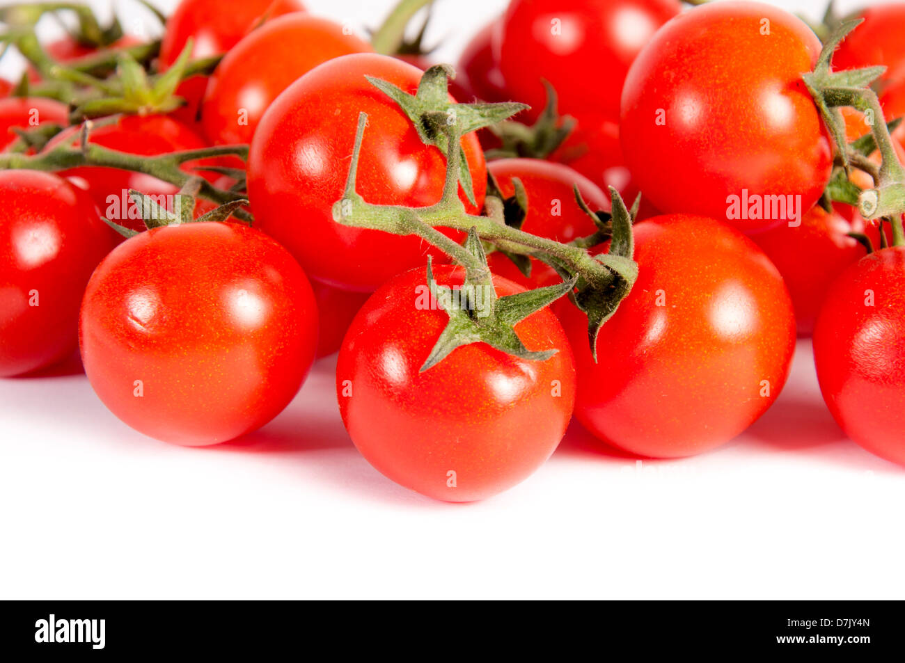 bunch of cherry tomatoes isolated on white background Stock Photo - Alamy
