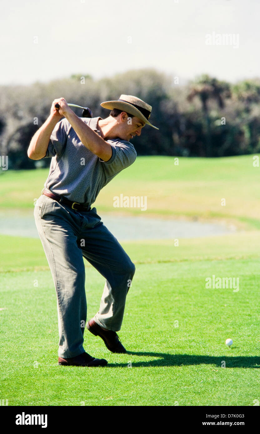 Male golfer hitting ball, Miami Stock Photo