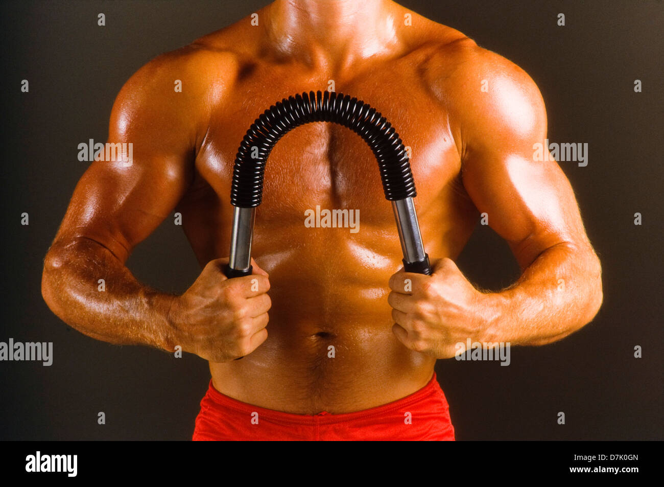 Male athlete in gym with exercise apparatus, concept, strength Stock Photo