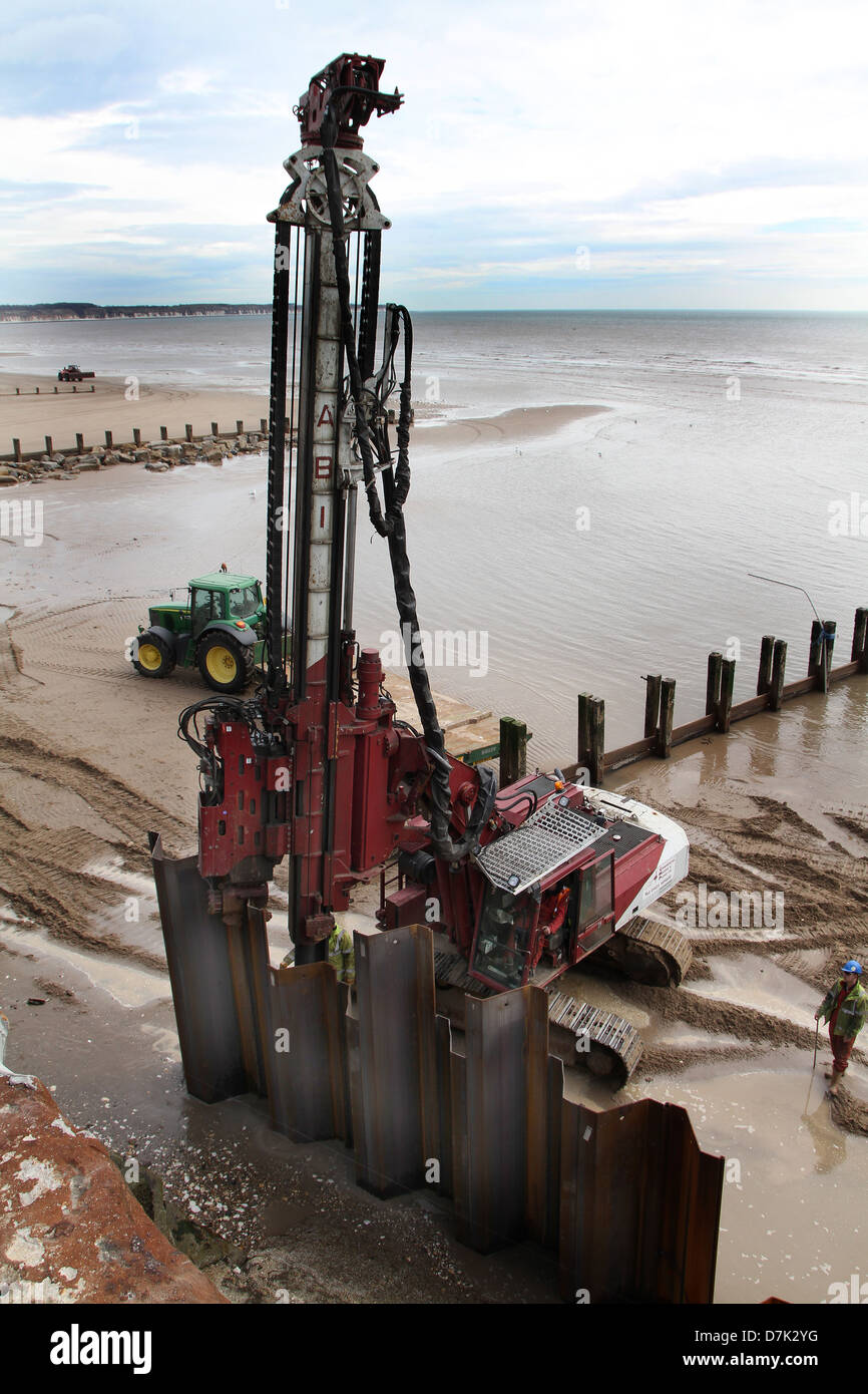 Strengthening sea wall with steel piles. Stock Photo