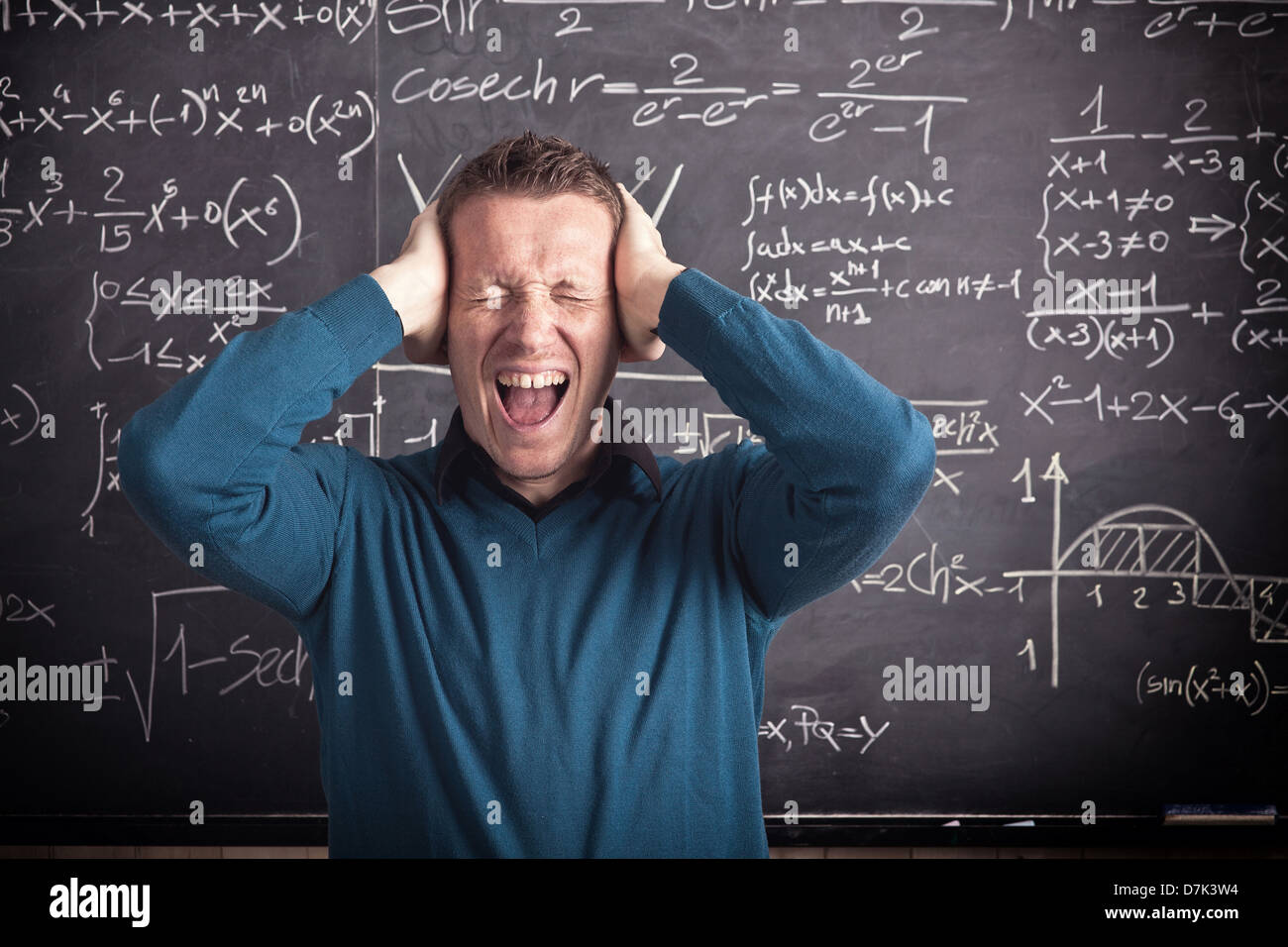 portrait of stressed caucasian teacher and blackboard Stock Photo