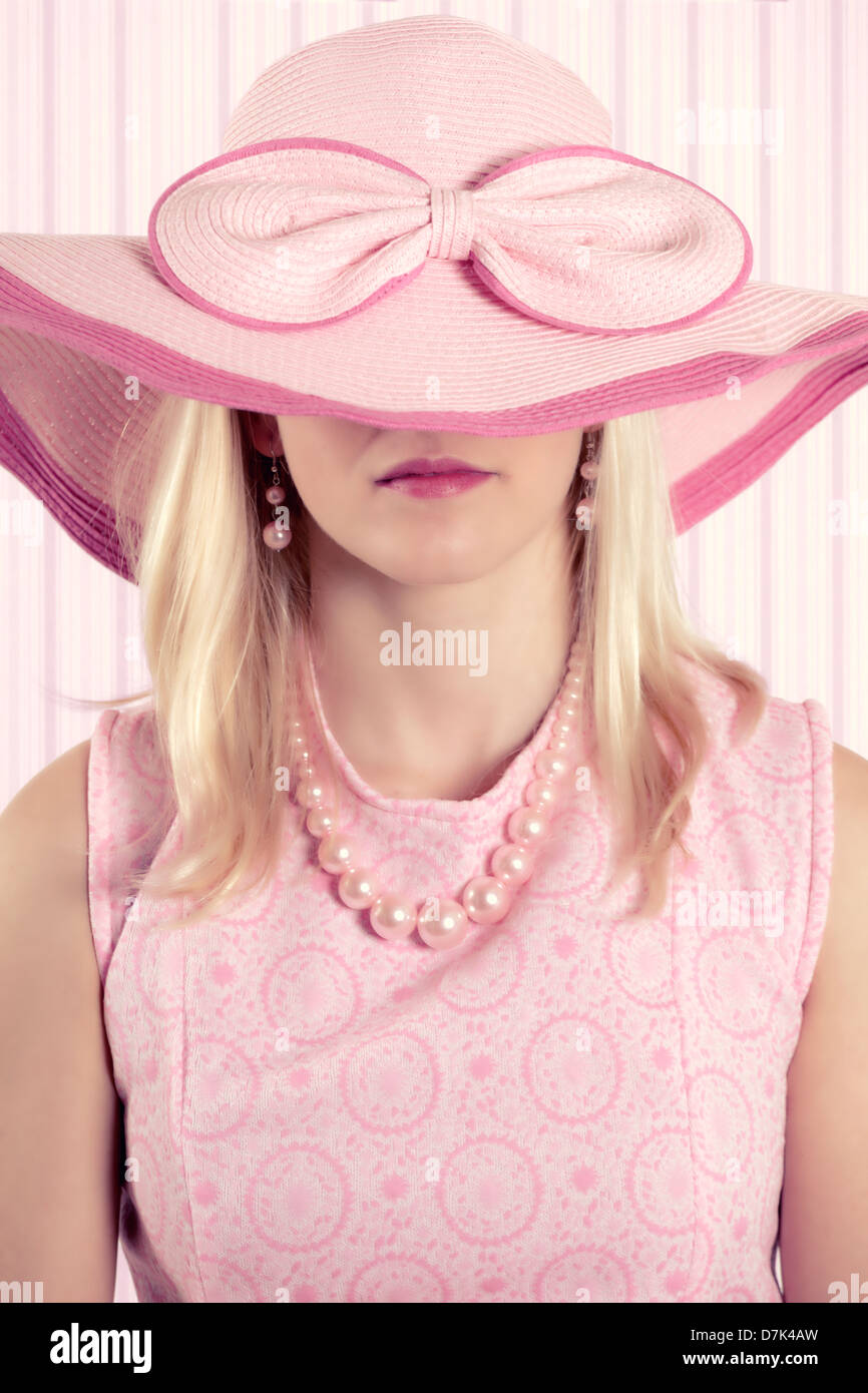 a girl in 60s style with a huge sunhat Stock Photo