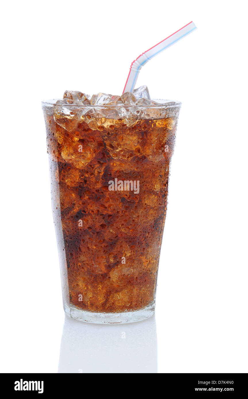 Glass filled with ice cubes and Cola soda over a white background. Glass is covered with condensation . Stock Photo