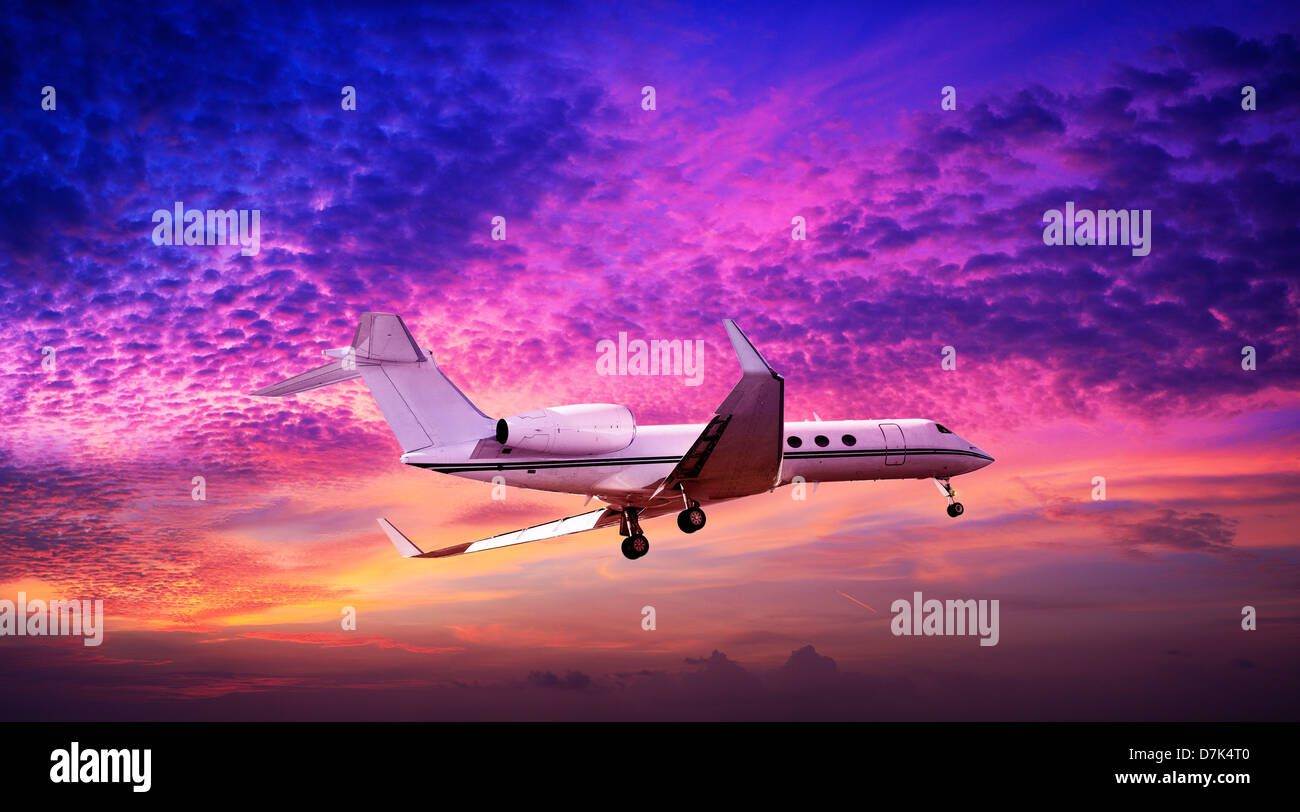 Private jet maneuvering in a spectacular sunset sky Stock Photo