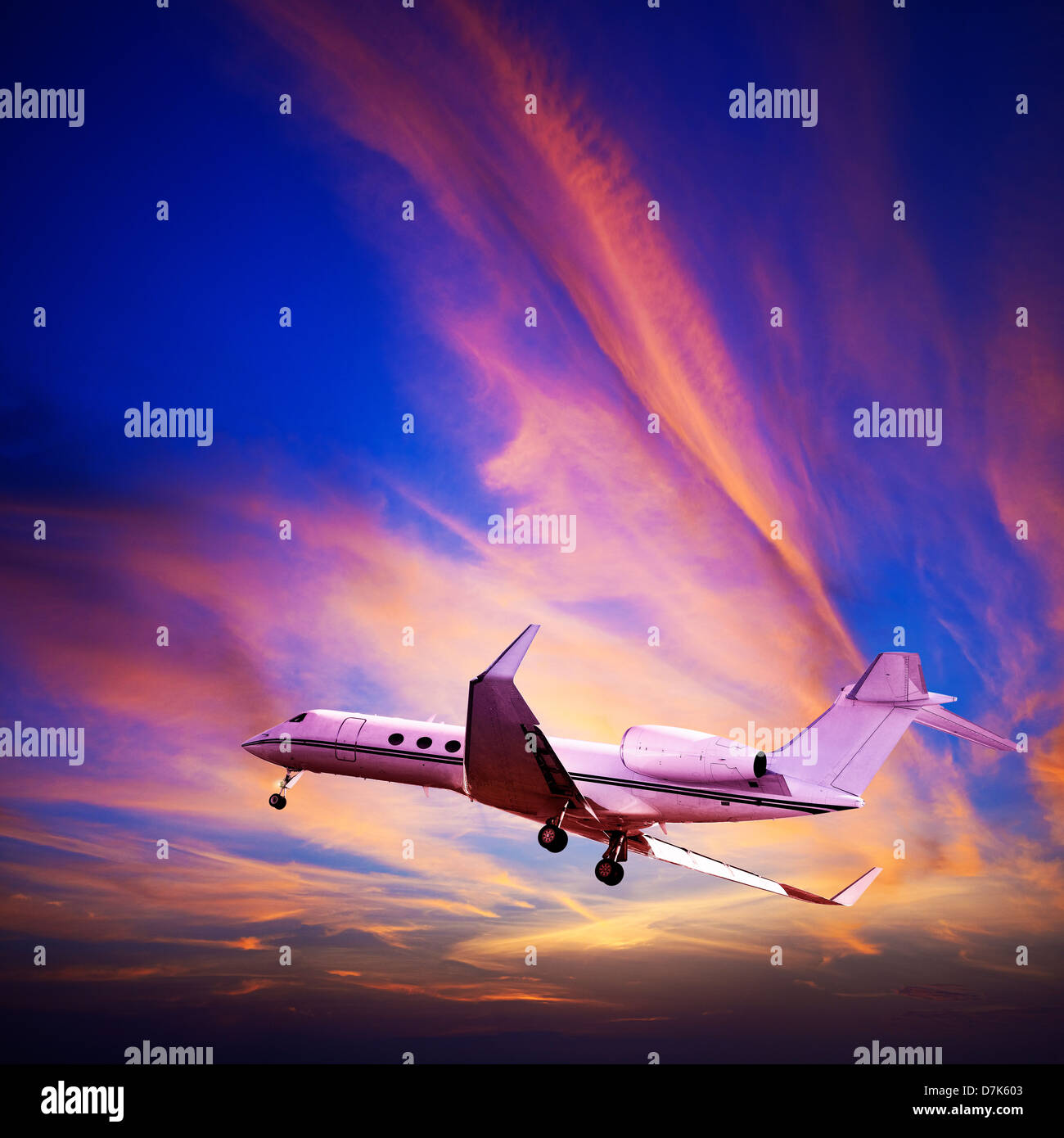 Private jet maneuvering in a spectacular sunset sky. Square composition. Stock Photo