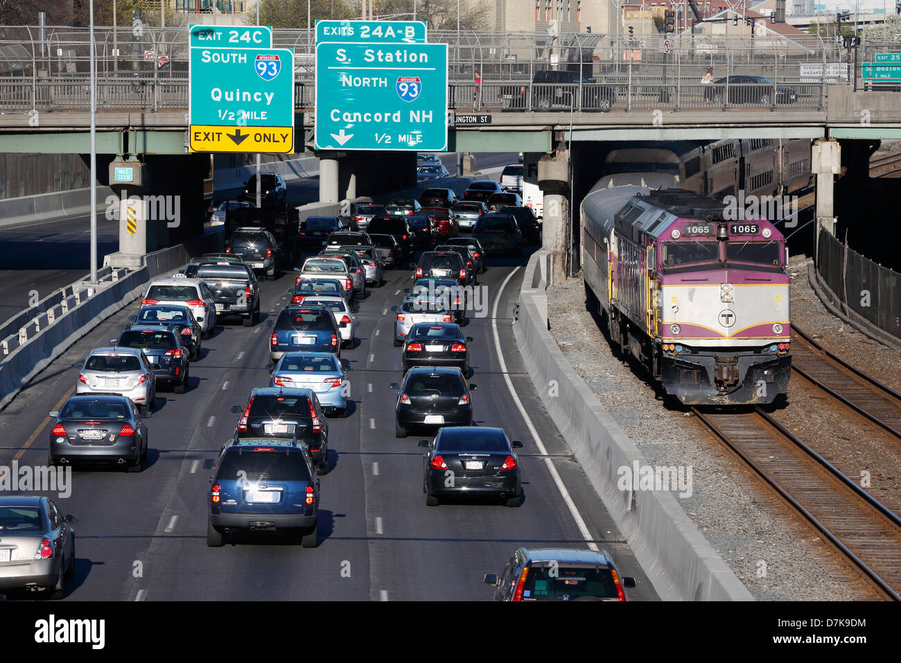 Cars on the Massachusetts Turnpike extension and a commuter rail train leaving South Station, Boston, Massachusetts Stock Photo