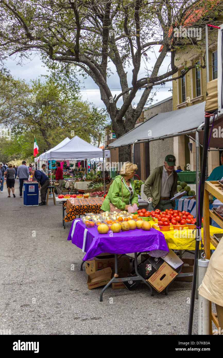 Woman speaks to vendor at farmers market Stock Photo