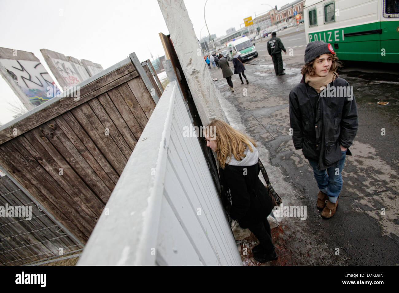 Berlin, Germany, young people at the East Side Gallery wall with missing segments Stock Photo
