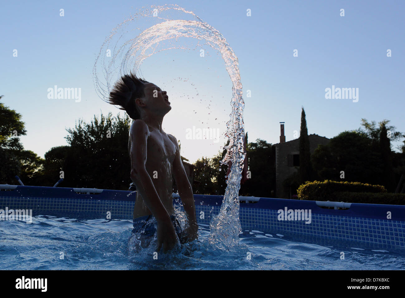 Torre Alfina, Italy, silhouette, boy throws his wet hair back in