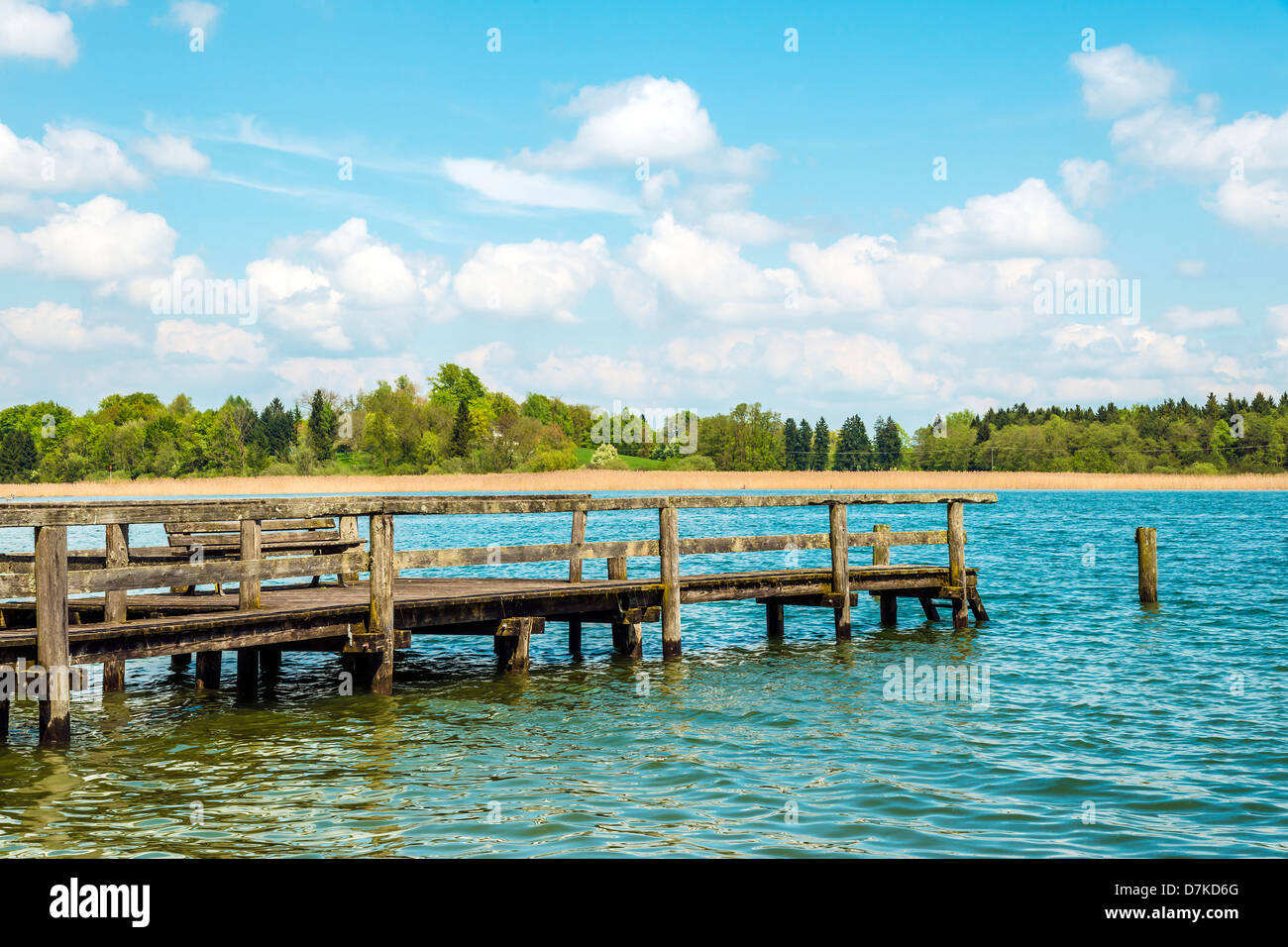 Dilapidated bathing jetty for relaxing in light, green nature at Chiemsee, Germany Stock Photo