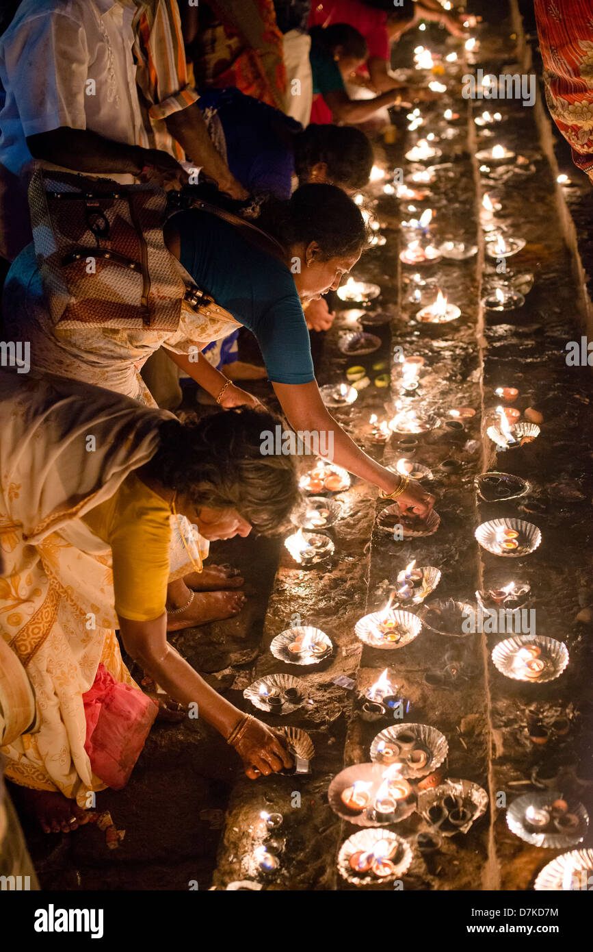 Hindu devotees light ghee lamps at a shrine near the Arunachaleswara