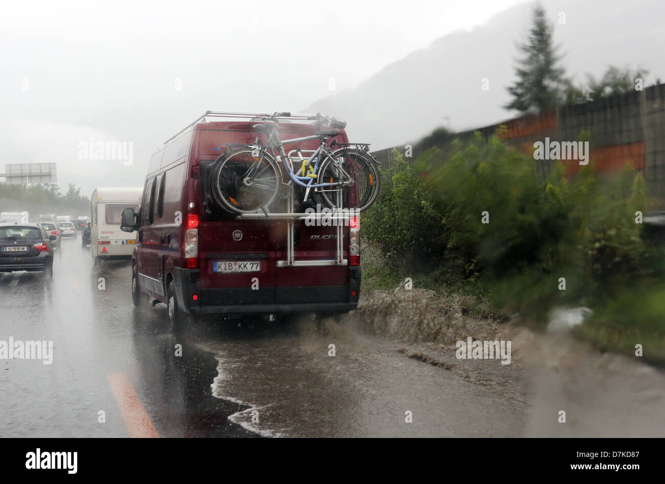 Venn, Austria, RV driving through a large puddle on the A13 motorway Stock Photo