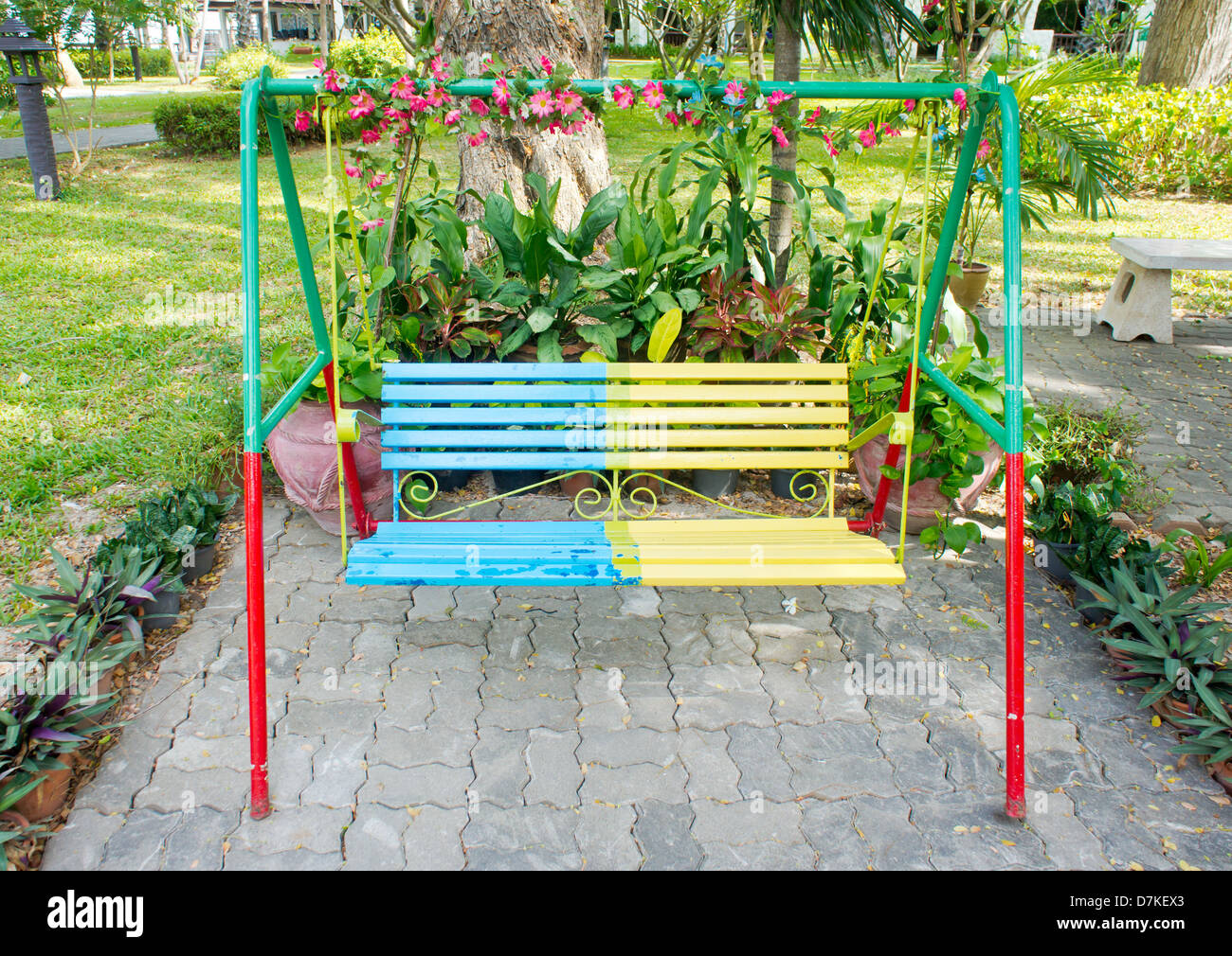 The colorful swing bench in a park Stock Photo - Alamy