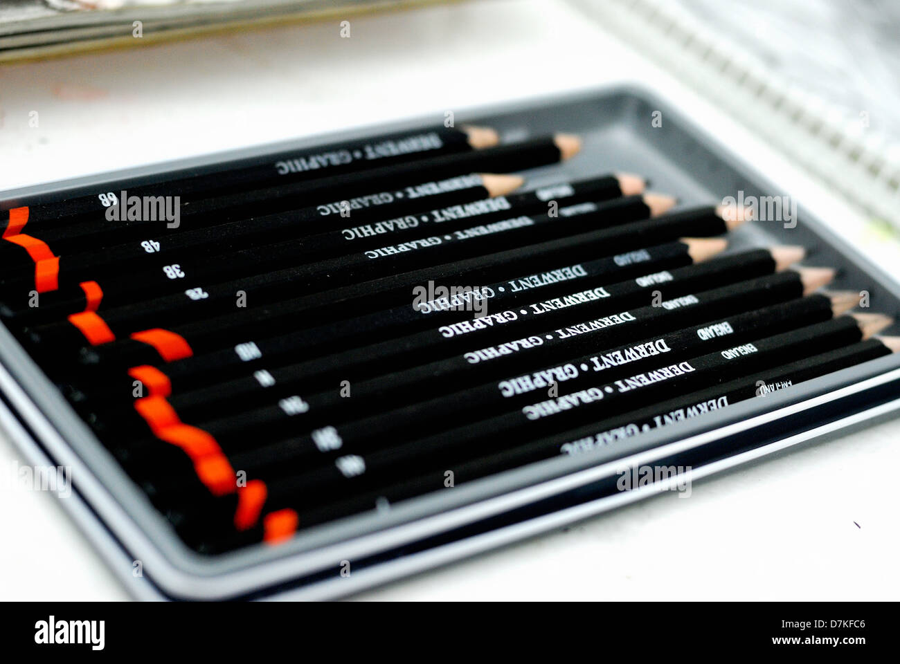 A tray of artist pencils Stock Photo