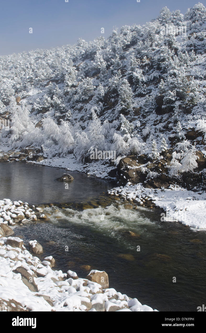 The Arkansas River and its surrounding mountains have been coated in a fresh layer of wet snow. Stock Photo