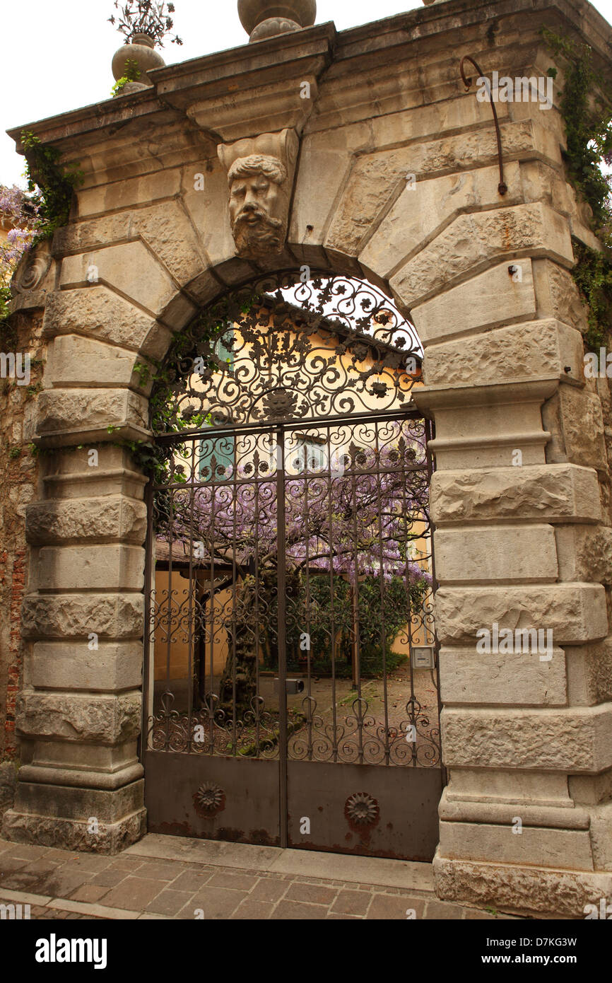 Ornate gate and garden in the city centre of Cividale del Friuli, Italy. Stock Photo