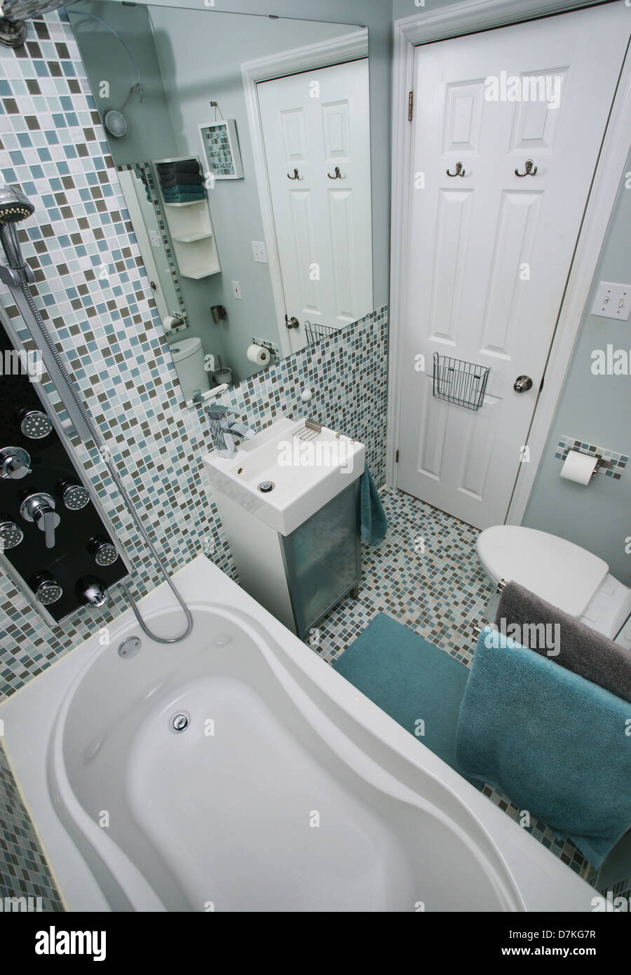 Small, modern bathroom interior. Mosaic tiles. White. Blue. Gray. Stock Photo