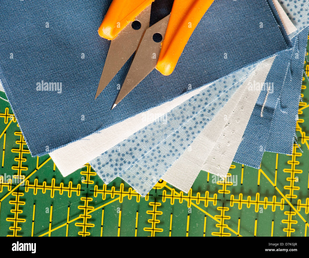 Quilting or patchwork materials and tools on a green measuring board