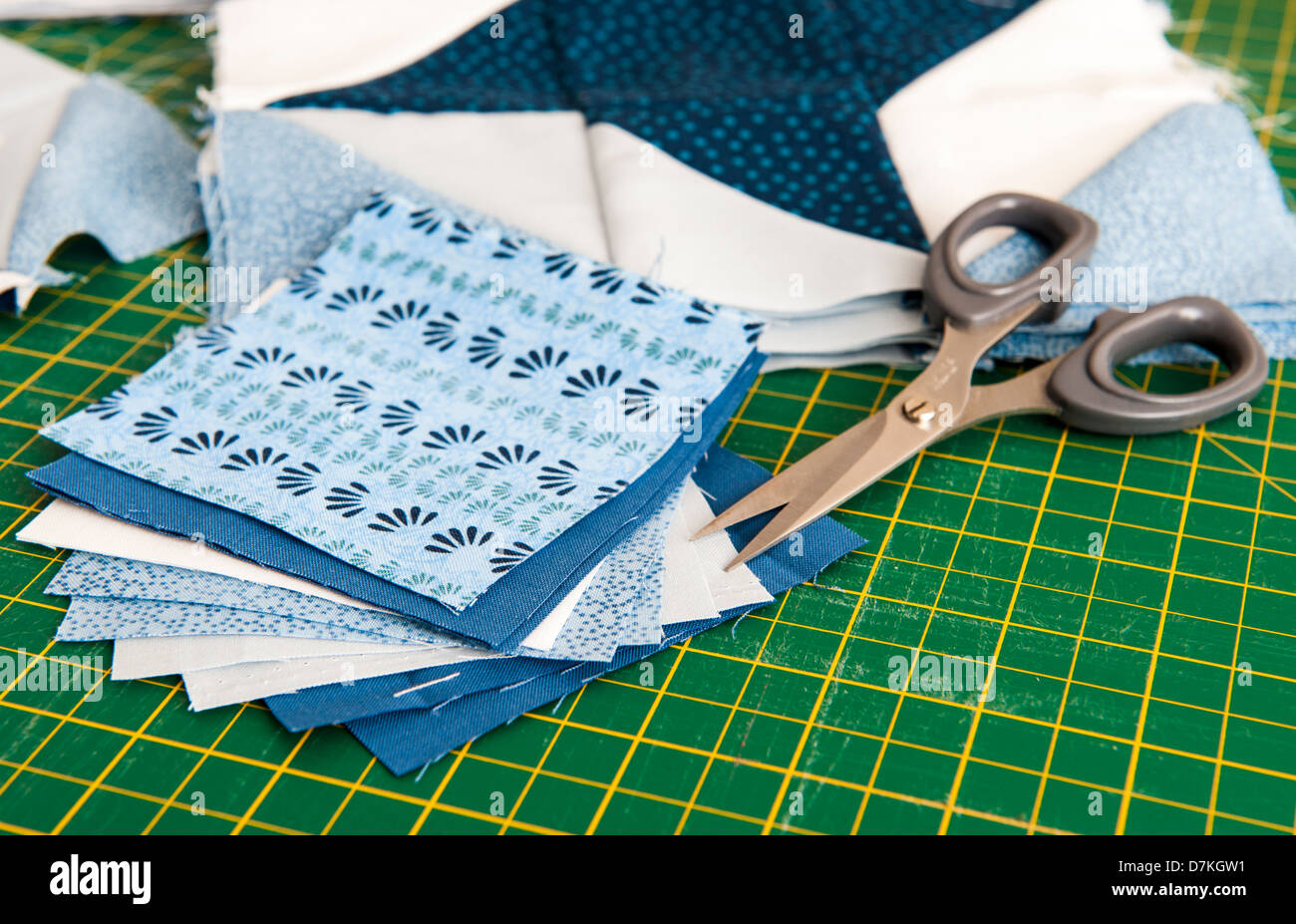 Quilting or patchwork materials and tools on a green measuring board