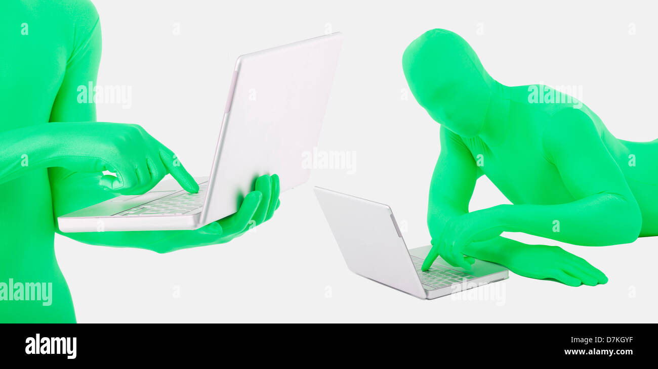 Men in green zentai using laptop Stock Photo