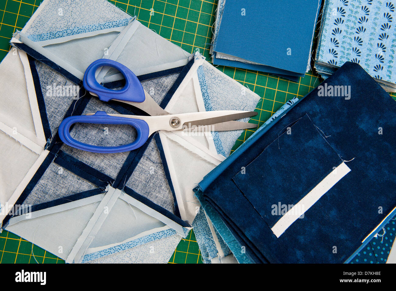 Quilting or patchwork materials and tools on a green measuring board