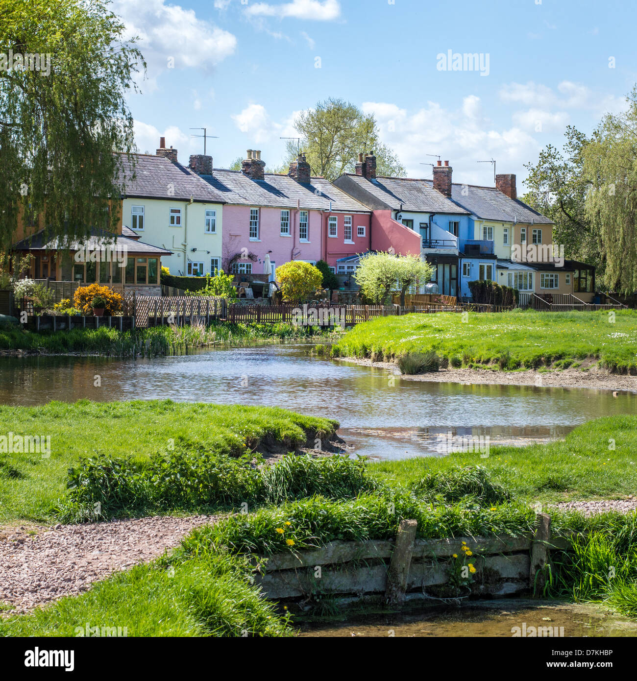 A row of colourful painted terraced houses overlook the river Stour and common-lane in Sudbury, Suffolk, England. Stock Photo