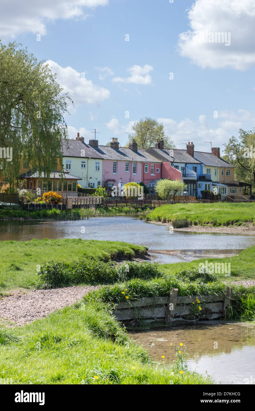 A row of colourful painted terraced houses overlook the river Stour and common-lane in Sudbury, Suffolk, England. Stock Photo