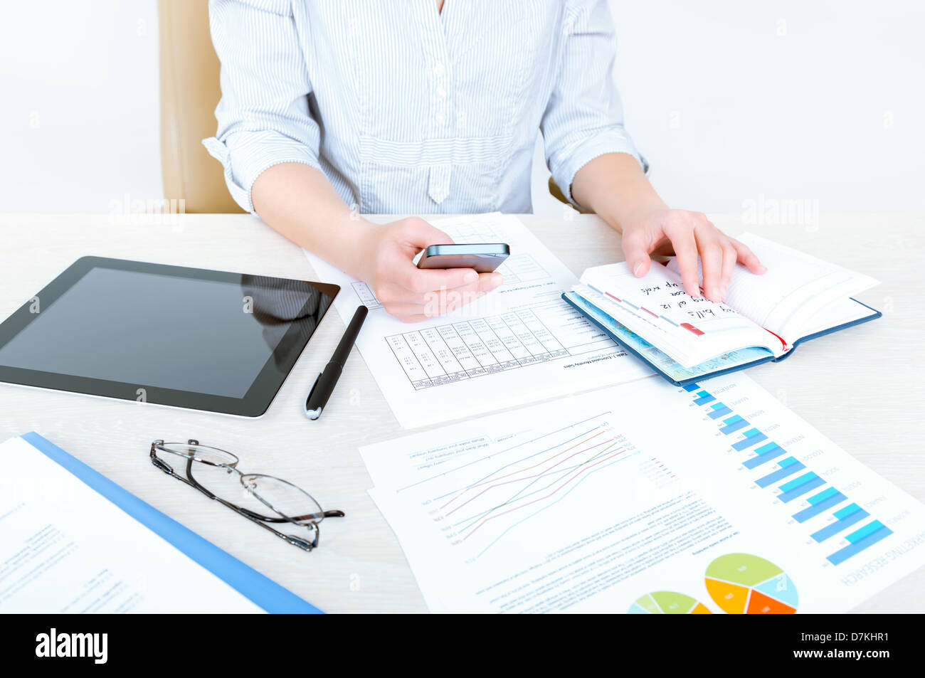 Successful businesswoman sitting at desk in casual clothes and planning her working day in the office Stock Photo