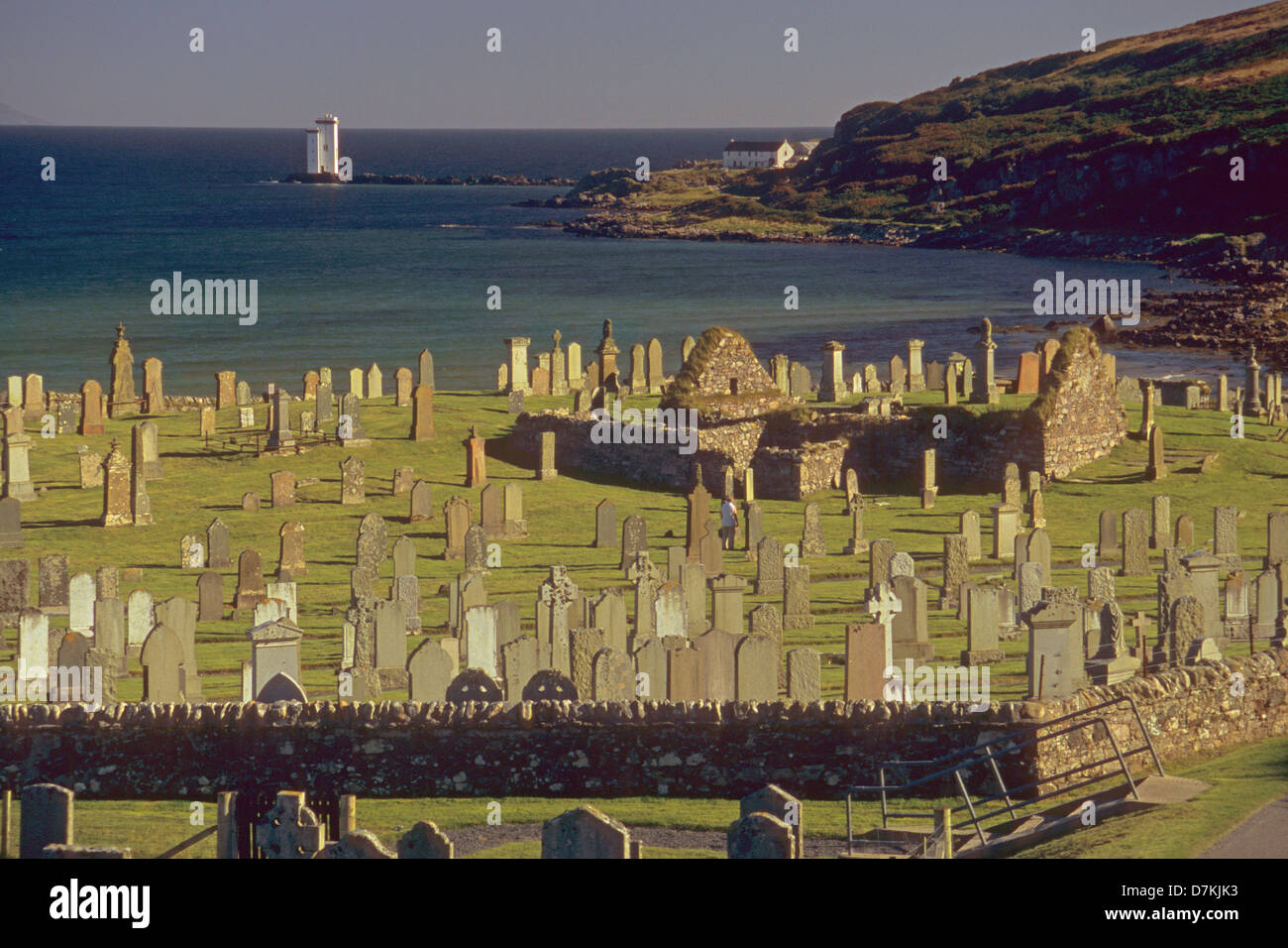 Kilnaughton Chapel and Carraig Fhada lighthouse near Port Ellen on the Isle of Islay Stock Photo