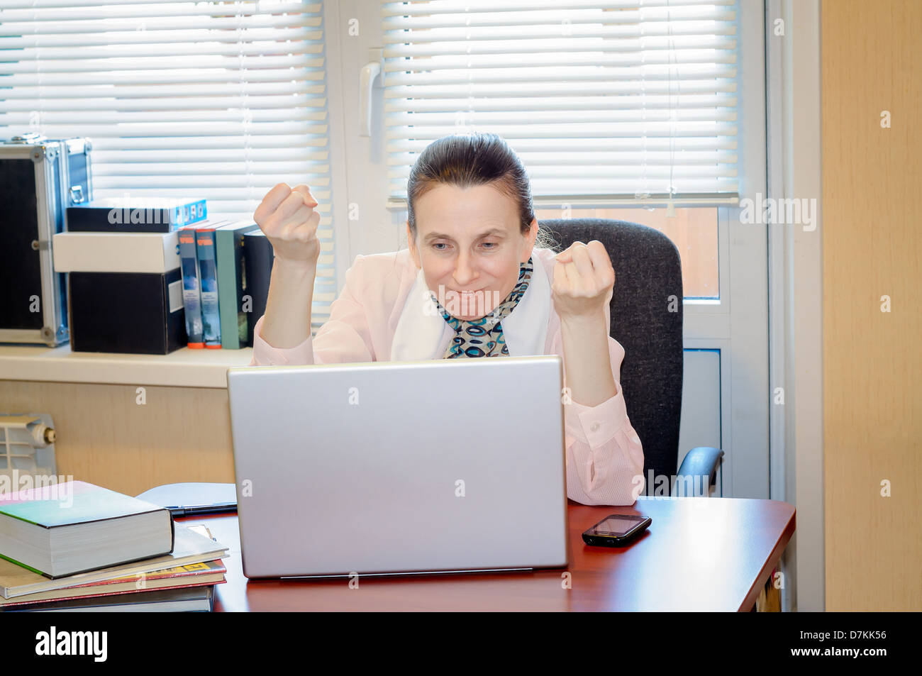 A fifty years old woman very angry with the modern technology Stock Photo