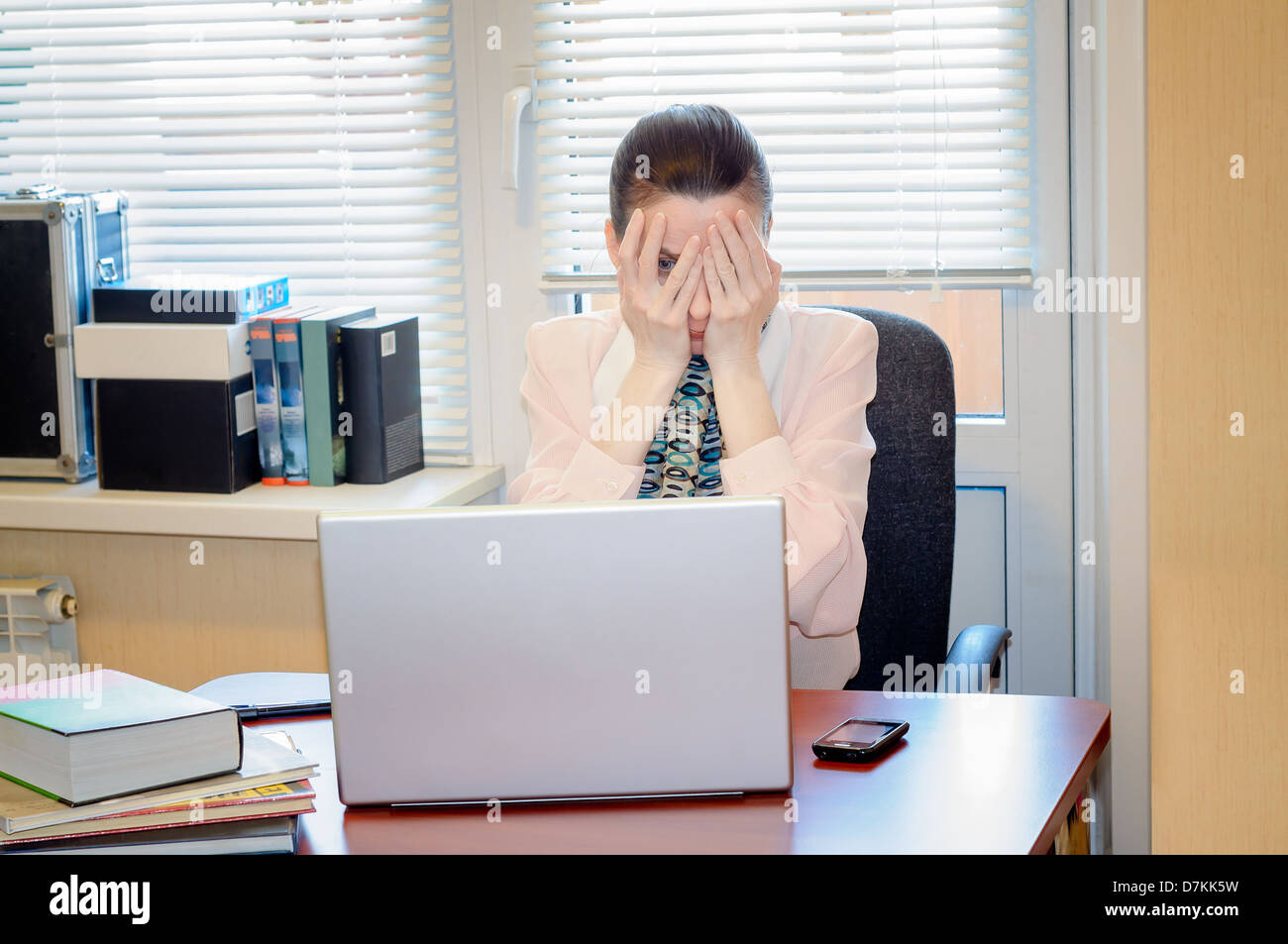 A fifty years old woman very angry with the modern technology Stock Photo