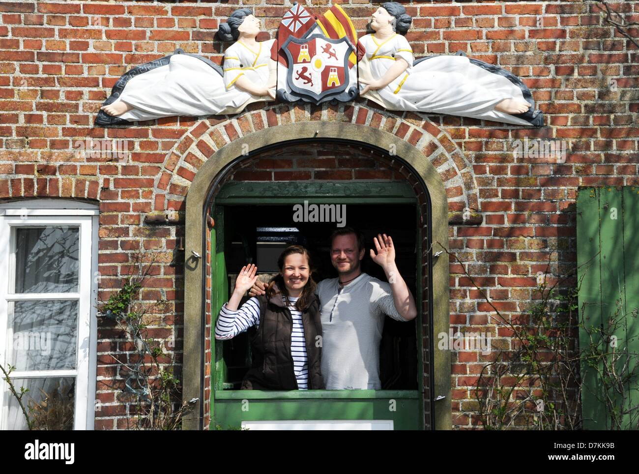 Holger Spreer and Nele Wree wave from their future home on the Hallig Suederoog, Germany, 07 May