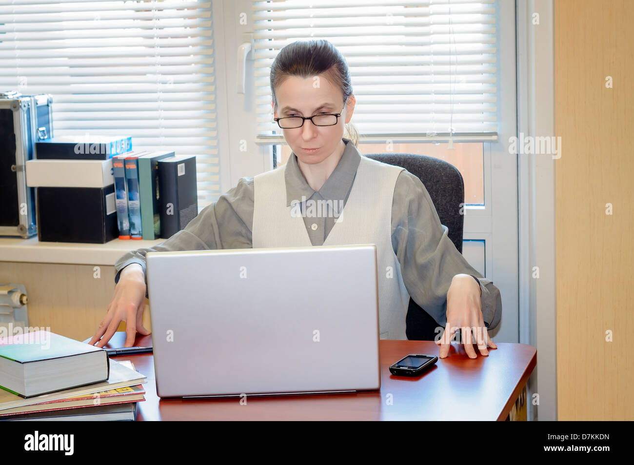 A fifty years old woman very angry with the modern technology Stock Photo